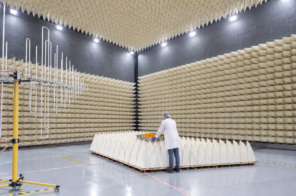 Illustration: a technician sets a tray of turmeric extract on the absorber-lined platform