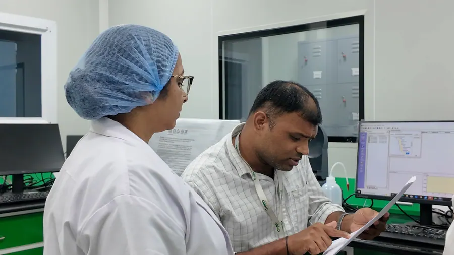 A scientist and an analyst at the instrument workstation