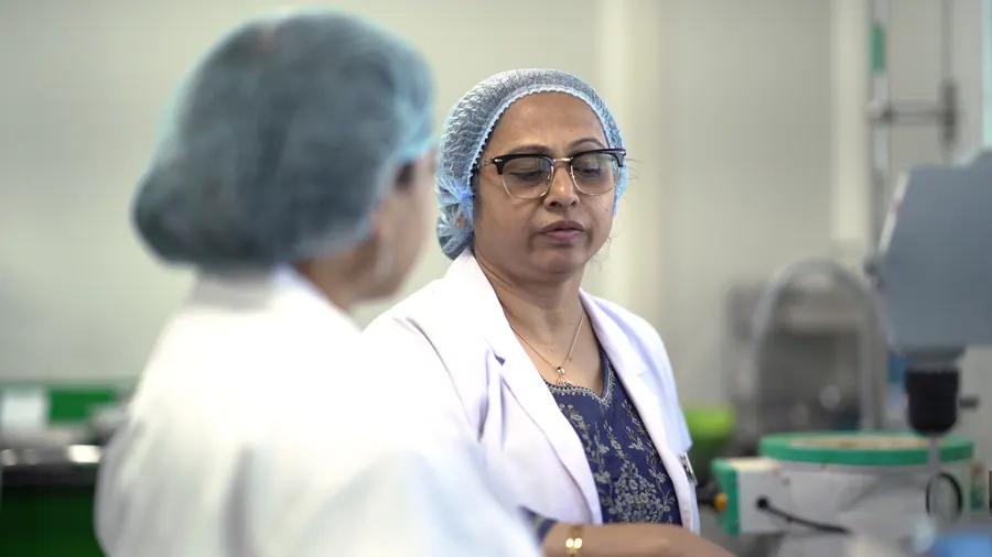 A senior scientist in discussion with a colleague
