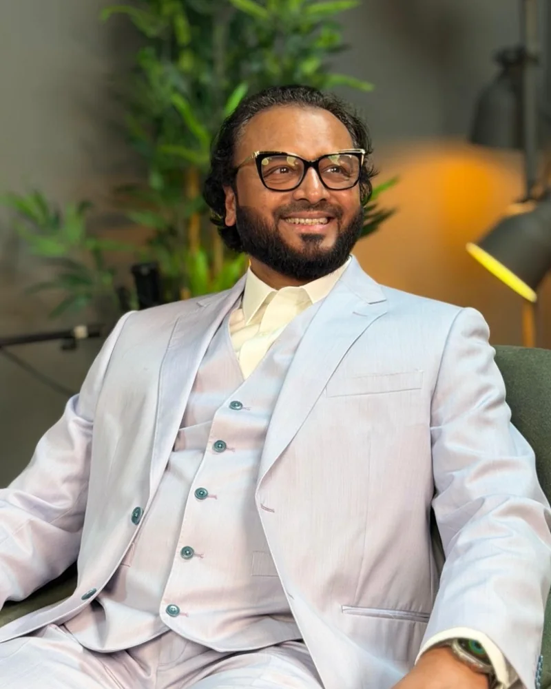 Hirehal Nuruddin Shafiulla, founder of GreenSpace Herbs, smiling in a light grey suit